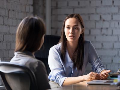 Two women in a meeting room in discussion